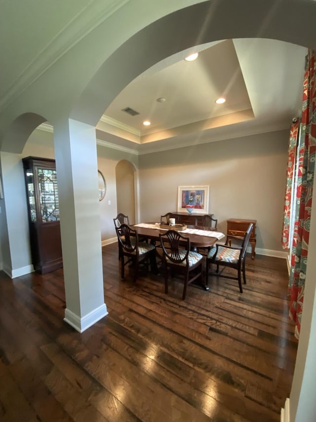 43 Secret St, Freeport, FL 32439 - dining room with arched walkways, a raised ceiling, dark wood finished floors, crown molding, and recessed lighting