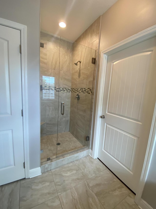 43 Secret St, Freeport, FL 32439 - bathroom with a shower stall, marble look tile flooring, and recessed lighting