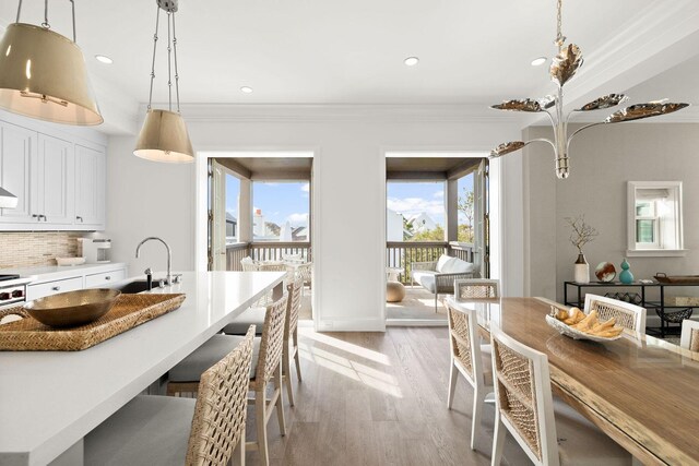 74 Town Hall Rd Unit 3B, Rosemary Beach, FL 32461 - dining space with light wood finished floors, baseboards, crown molding, and recessed lighting