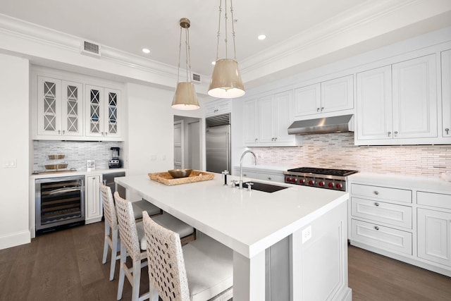 74 Town Hall Rd Unit 3B, Rosemary Beach, FL 32461 - kitchen featuring light countertops, under cabinet range hood, a sink, beverage cooler, and appliances with stainless steel finishes