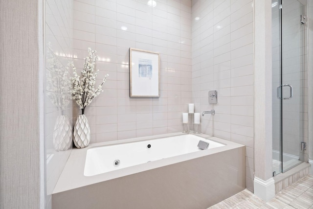 74 Town Hall Rd Unit 3B, Rosemary Beach, FL 32461 - full bathroom featuring a stall shower, tile walls, and a garden tub