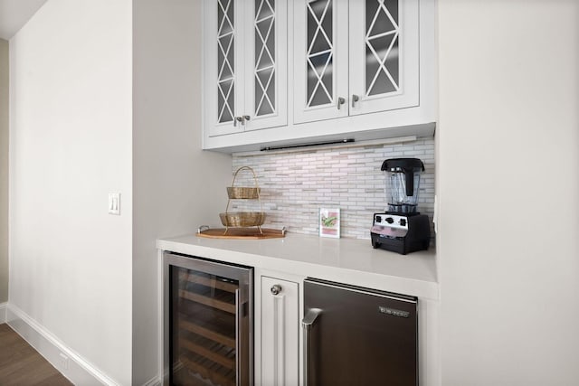 74 Town Hall Rd Unit 3B, Rosemary Beach, FL 32461 - bar with wine cooler, tasteful backsplash, bar area, baseboards, and dark wood-type flooring