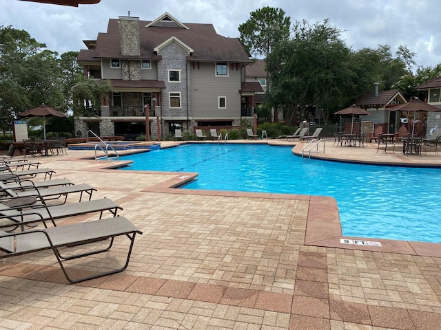 pool with fence and a patio