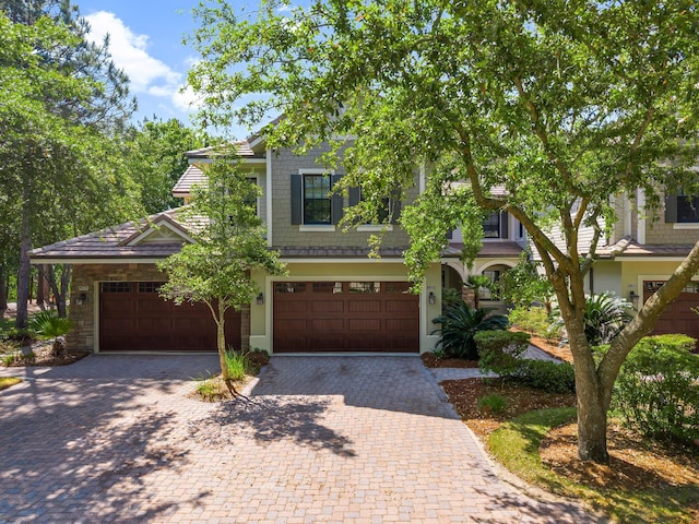 view of front facade with decorative driveway and a garage