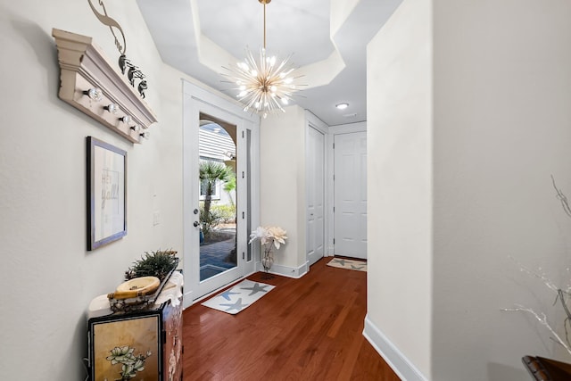 entryway with baseboards, recessed lighting, wood finished floors, and a chandelier