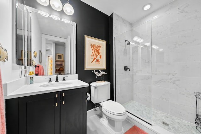 full bathroom featuring vanity, baseboards, a stall shower, and toilet