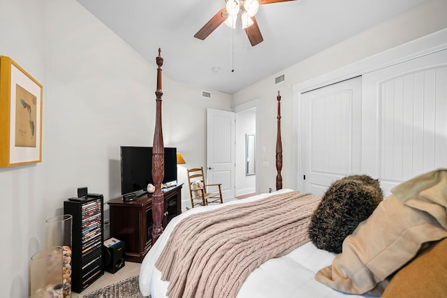 carpeted bedroom with a ceiling fan, visible vents, and a closet