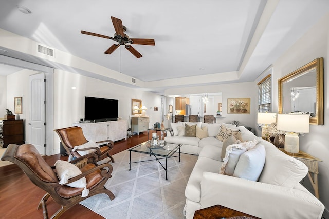 living area featuring ceiling fan, wood finished floors, and visible vents