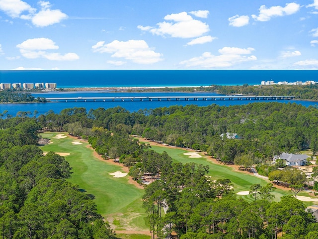 drone / aerial view with a water view and golf course view