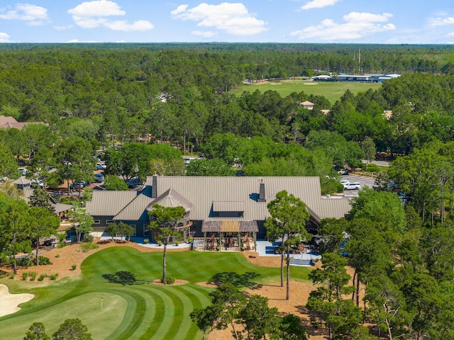 bird's eye view with view of golf course and a view of trees