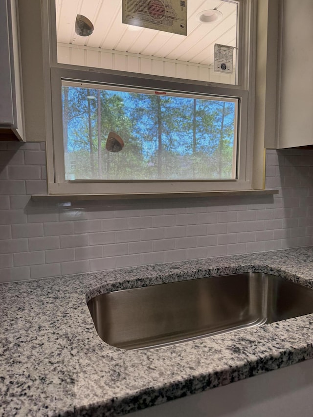 room details with light stone counters and tasteful backsplash