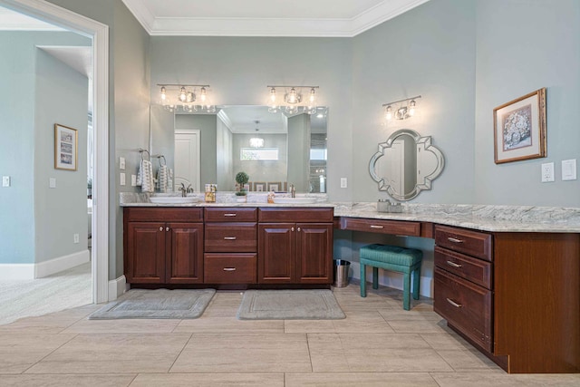 bathroom featuring baseboards, double vanity, ornamental molding, and a sink