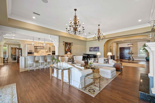 living room with arched walkways, dark wood-style flooring, crown molding, and a notable chandelier