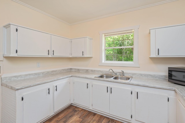 375 N Norwood Rd, Defuniak Springs, FL 32433 - kitchen with a sink, stainless steel microwave, ornamental molding, light countertops, and white cabinetry
