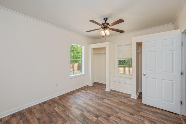 375 N Norwood Rd, Defuniak Springs, FL 32433 - unfurnished bedroom with dark wood-style floors, crown molding, baseboards, a closet, and ceiling fan