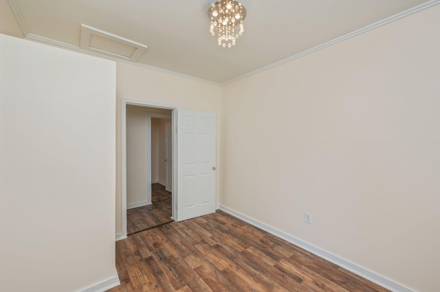 375 N Norwood Rd, Defuniak Springs, FL 32433 - spare room with dark wood-style flooring, baseboards, attic access, and ornamental molding