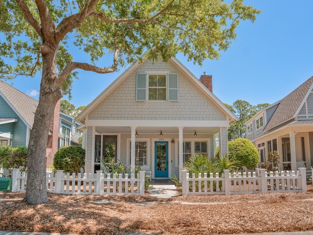 253 Salt Box Ln, Watersound, FL 32461 - bungalow-style home featuring a chimney, a porch, and a fenced front yard