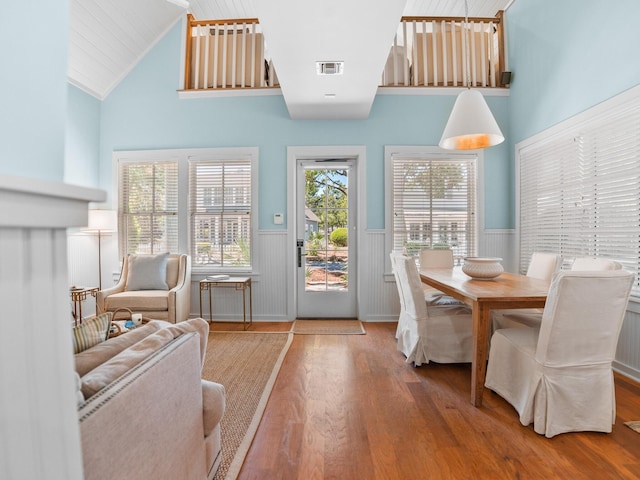 253 Salt Box Ln, Watersound, FL 32461 - dining area featuring a wainscoted wall, wood finished floors, and lofted ceiling