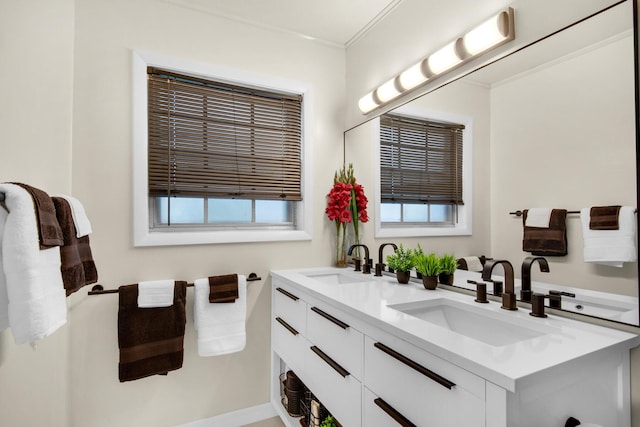 full bathroom with double vanity, a sink, and ornamental molding