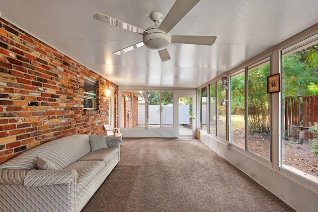 unfurnished sunroom featuring an outdoor hangout area and a ceiling fan
