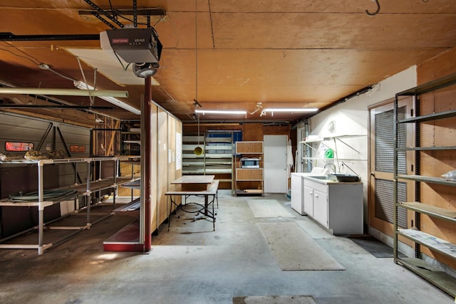 below grade area with washing machine and clothes dryer and a garage
