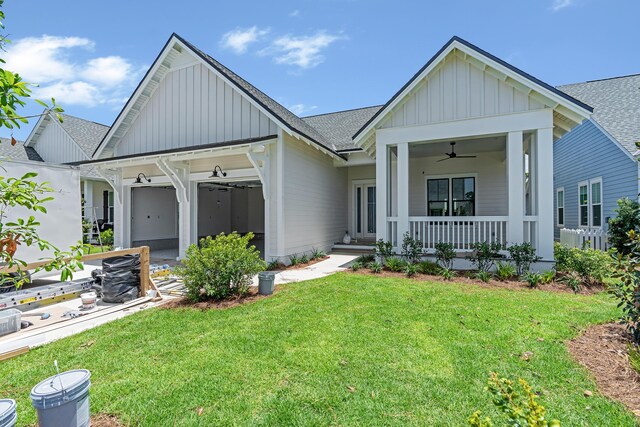 203 E Firethorn Cir Lot 24, Watersound, FL 32461 - view of front of house with board and batten siding, a shingled roof, covered porch, and a front yard