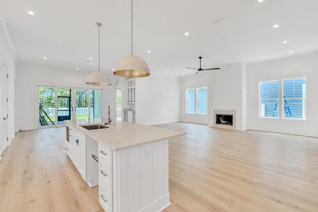 203 E Firethorn Cir Lot 24, Watersound, FL 32461 - kitchen with light wood finished floors, plenty of natural light, white cabinetry, a center island with sink, and recessed lighting