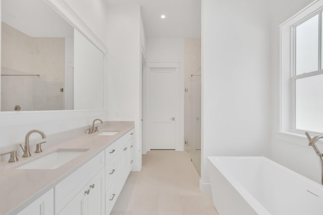203 E Firethorn Cir Lot 24, Watersound, FL 32461 - full bathroom featuring a shower stall, a freestanding bath, double vanity, and recessed lighting