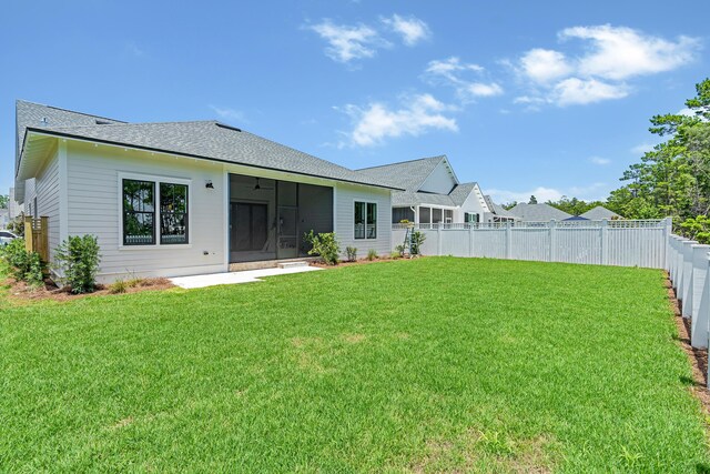 203 E Firethorn Cir Lot 24, Watersound, FL 32461 - rear view of property with a sunroom, a fenced backyard, and a shingled roof