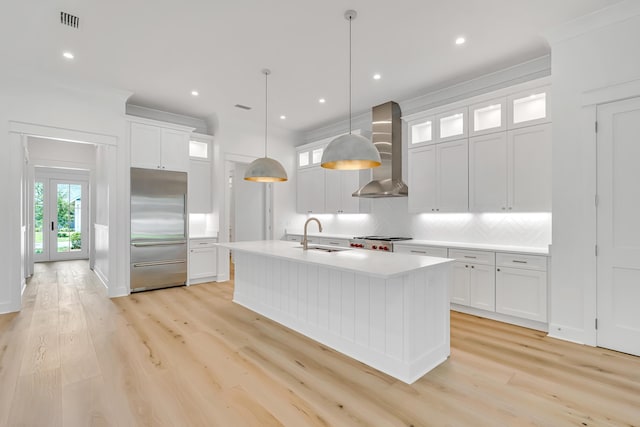 203 E Firethorn Cir Lot 24, Watersound, FL 32461 - kitchen with stainless steel built in refrigerator, wall chimney range hood, backsplash, light countertops, and light wood-style floors