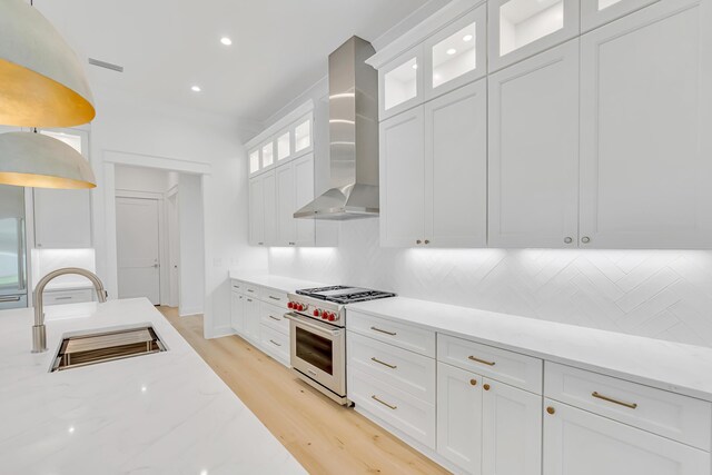 203 E Firethorn Cir Lot 24, Watersound, FL 32461 - kitchen featuring designer range, wall chimney exhaust hood, decorative backsplash, white cabinetry, and recessed lighting
