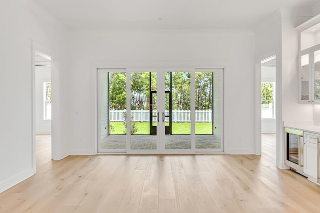 203 E Firethorn Cir Lot 24, Watersound, FL 32461 - entryway with wine cooler, plenty of natural light, light wood finished floors, french doors, and ornamental molding
