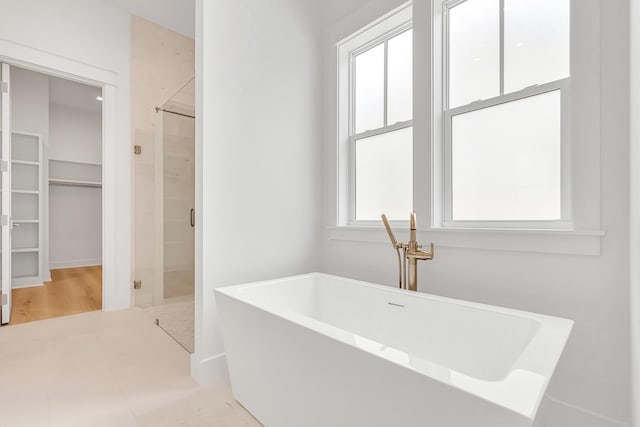 203 E Firethorn Cir Lot 24, Watersound, FL 32461 - full bath featuring a spacious closet, a freestanding bath, and a shower stall