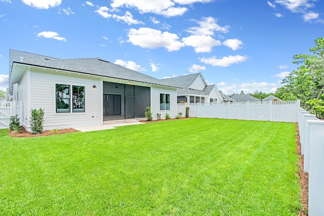 203 E Firethorn Cir Lot 24, Watersound, FL 32461 - back of property featuring a fenced backyard, a sunroom, and roof with shingles