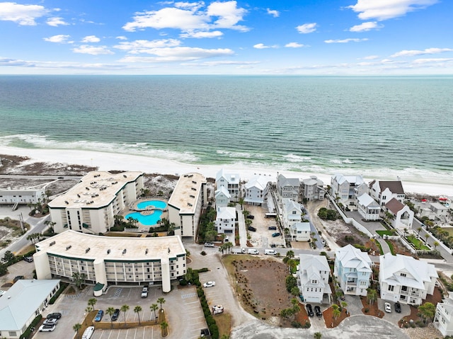 drone / aerial view with a water view and a beach view