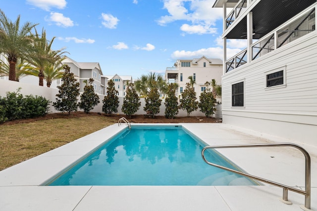 view of swimming pool with a fenced backyard, a fenced in pool, a yard, and a patio area