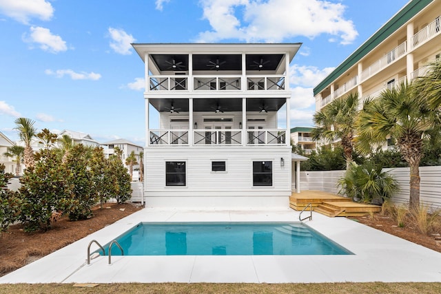 back of house featuring a fenced in pool, fence, a balcony, a patio, and ceiling fan