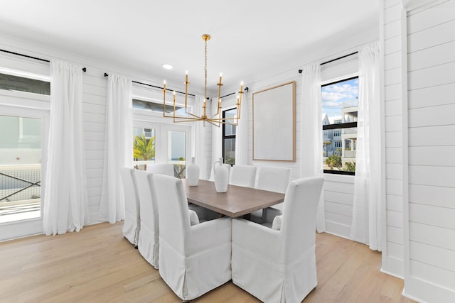 dining space with an inviting chandelier and light wood-style floors