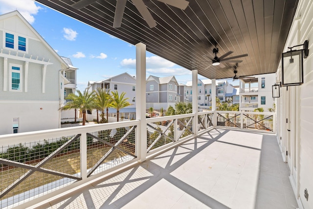 balcony with a residential view and ceiling fan