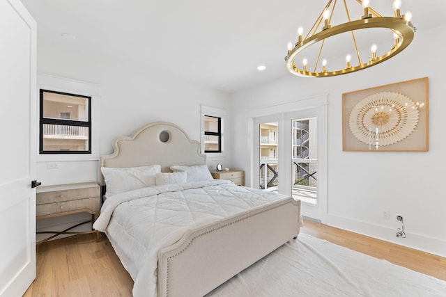 bedroom featuring baseboards, light wood-style flooring, a chandelier, and recessed lighting