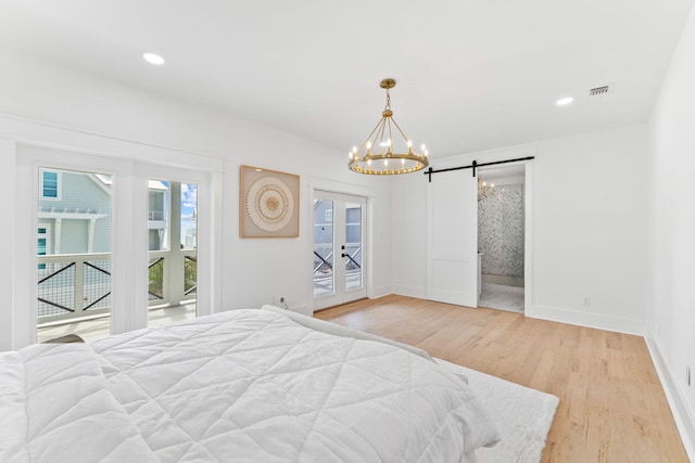 bedroom with visible vents, baseboards, access to exterior, light wood-type flooring, and a notable chandelier