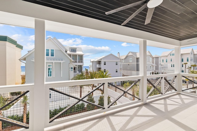 view of patio featuring a ceiling fan, a residential view, and a balcony