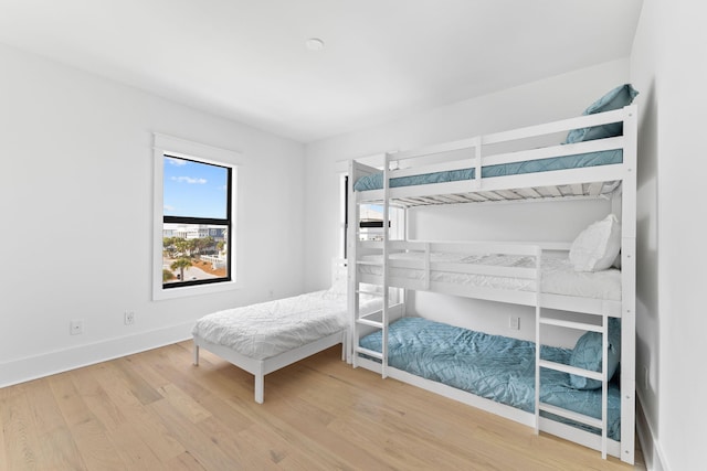 bedroom with baseboards and wood finished floors