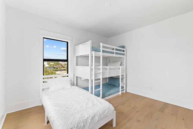 bedroom with baseboards and wood finished floors