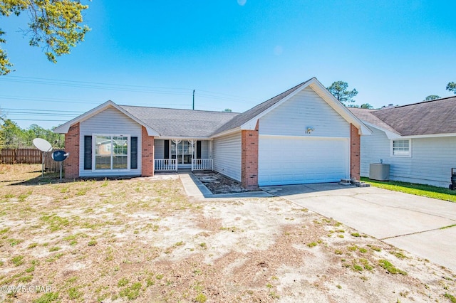 ranch-style home featuring fence, a garage, concrete driveway, brick siding, and cooling unit