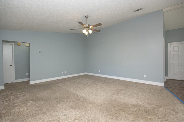 carpeted spare room with visible vents, a textured ceiling, baseboards, and ceiling fan