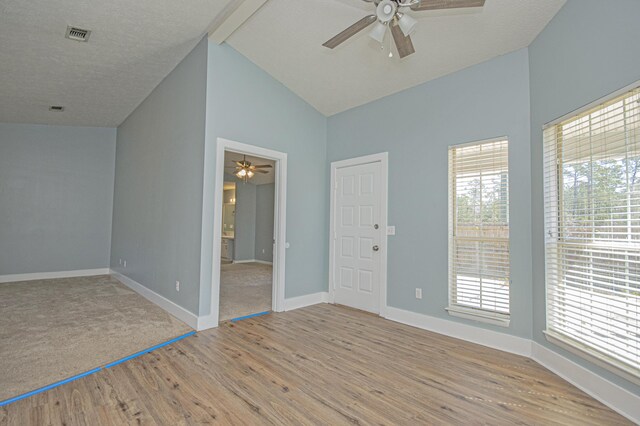 empty room featuring light wood finished floors, a wealth of natural light, and ceiling fan