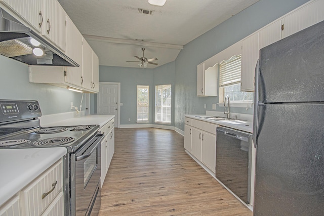 kitchen featuring a sink, light wood-type flooring, under cabinet range hood, black appliances, and ceiling fan