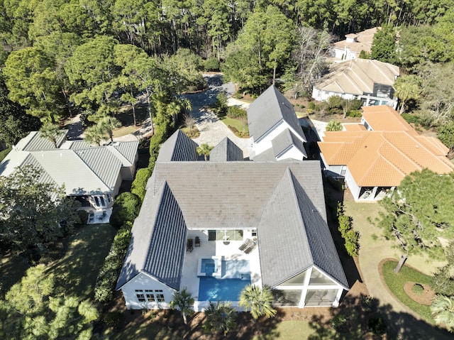 birds eye view of property with a view of trees