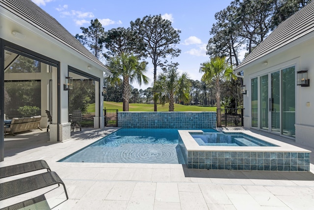 outdoor pool with view of golf course, a patio area, and an in ground hot tub